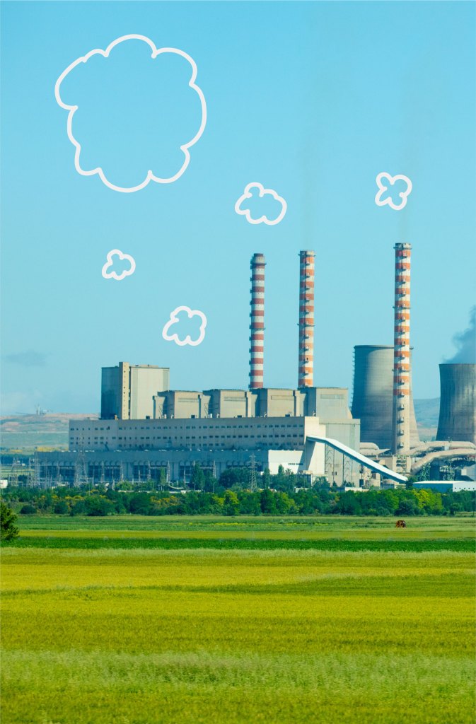 A green field with a power plant in the background.