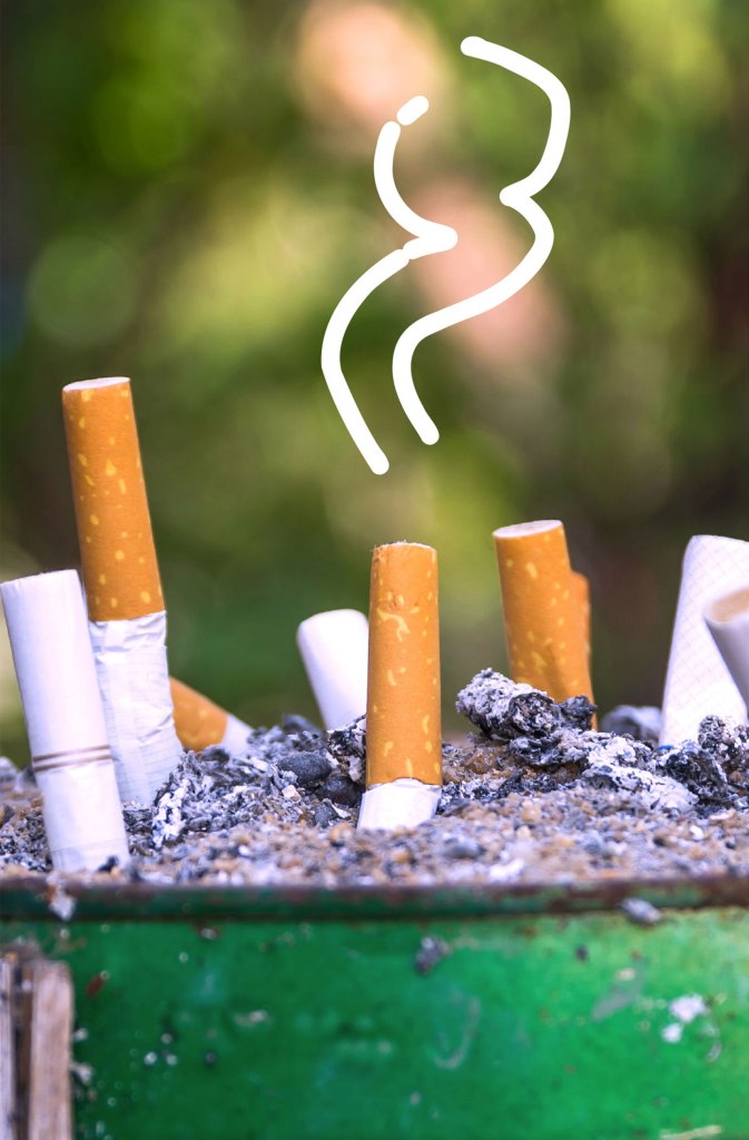 A group of cigarettes sitting in a trash can.