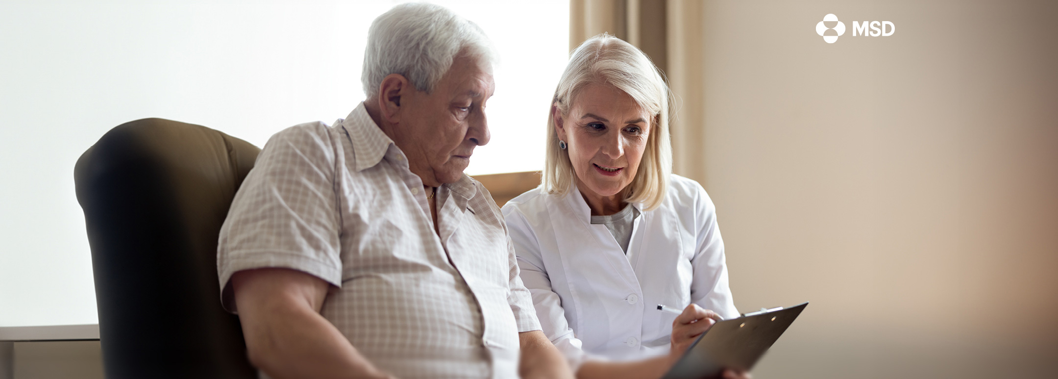 A female doctor talks to an older man.